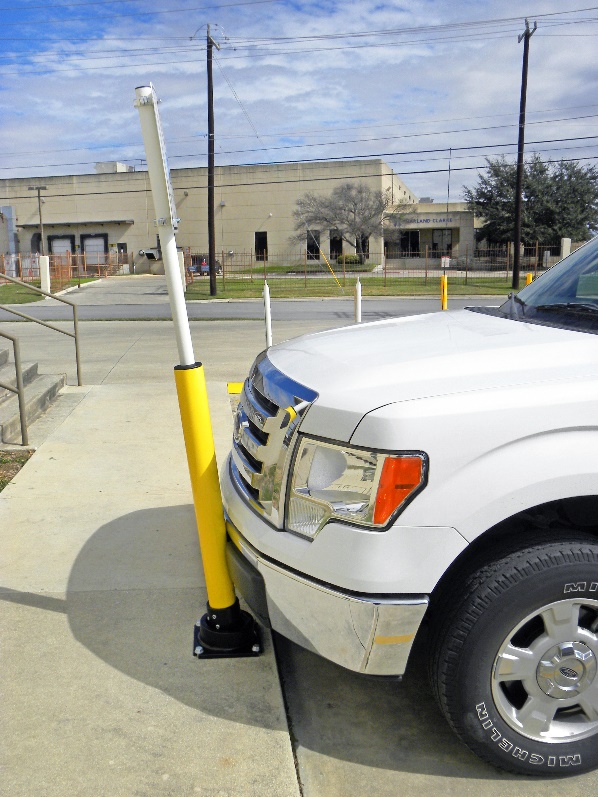 Rebounding bollard prevents white truck from entering pedestrian sidewalk Rebounding bollard prevents white truck from entering pedestrian sidewalk